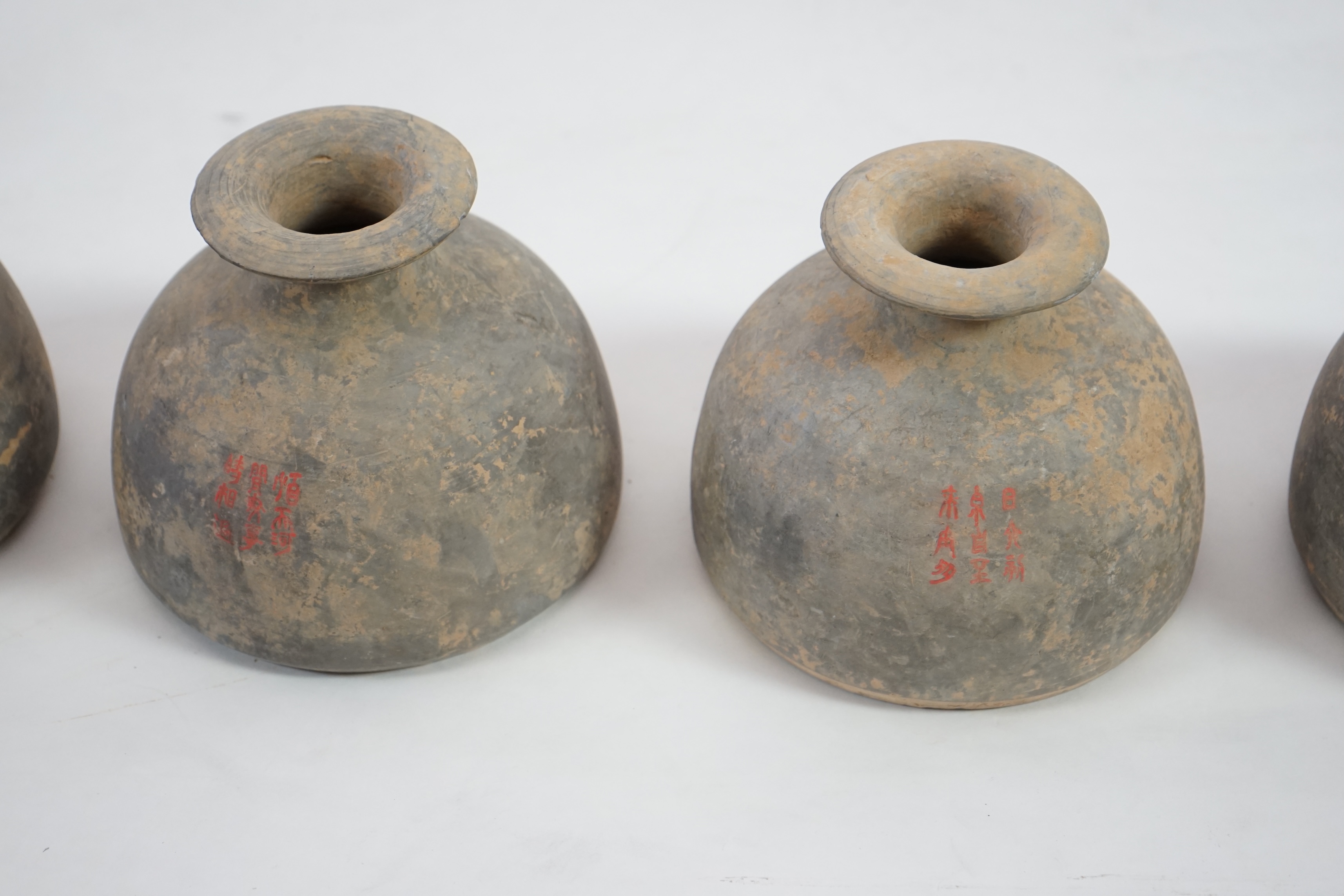 Four very rare Chinese inscribed pottery jars, Han dynasty